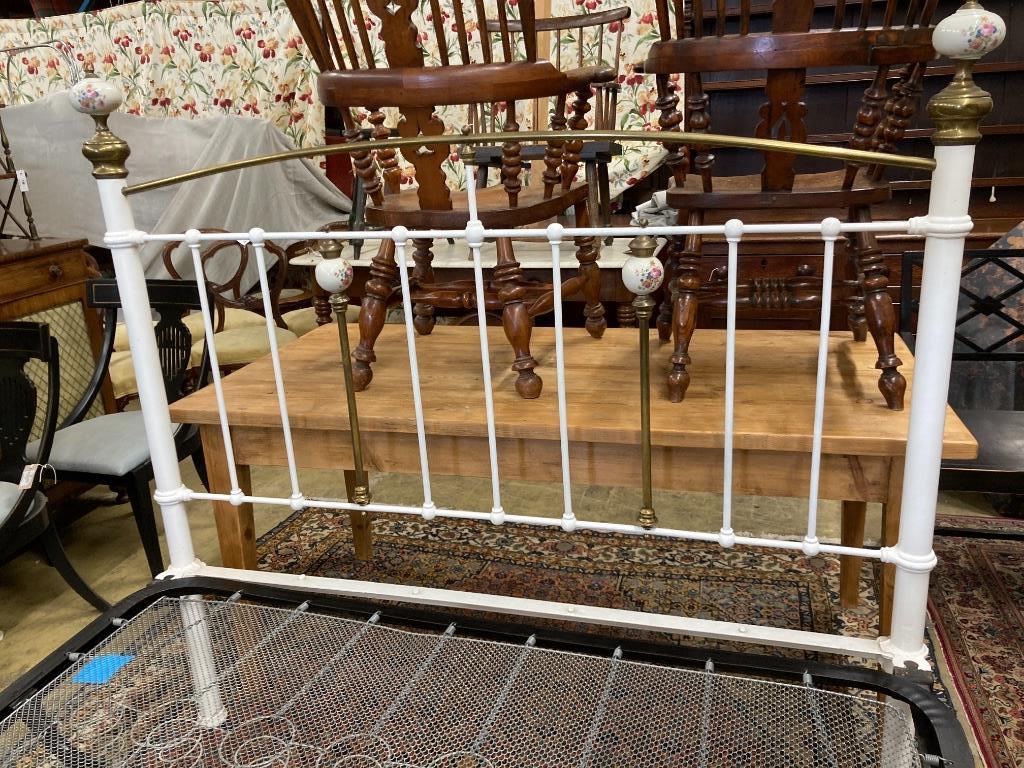 A Victorian style brass and painted iron porcelain mounted bed frame, width 150cm, length 210cm